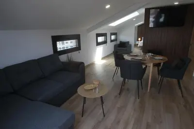 a living room with a couch and a table at Tierra de Lemos- Apartamentos Turísticos in Monforte de Lemos