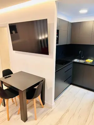 a kitchen with a black table and black cabinets at APARTAMENTOS NADA Ó NORTE Centro in Viveiro