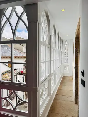 a hallway with windows and a view of a building at APARTAMENTOS NADA Ó NORTE Centro in Viveiro