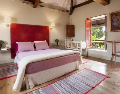 a bedroom with a large bed with a red headboard at Apartamento Coral in Villamejil