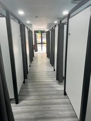 a hallway in an office with a row of lockers at O Albergue de Fene in Fene