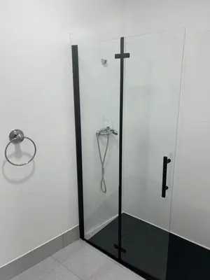 a shower with a glass door with a cross on it at O Albergue de Fene in Fene