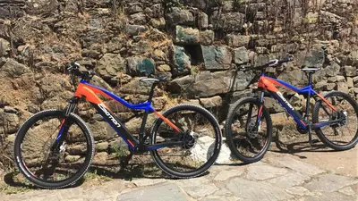 two bikes parked next to a stone wall at Pazo Santa María in Arzúa