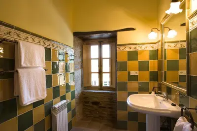 a bathroom with a sink and a window at Pazo Santa María in Arzúa