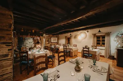 a restaurant with tables and chairs in a room at Pazo Santa María in Arzúa