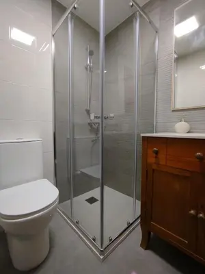 a bathroom with a shower with a toilet and a sink at MARSÁN in Arzúa