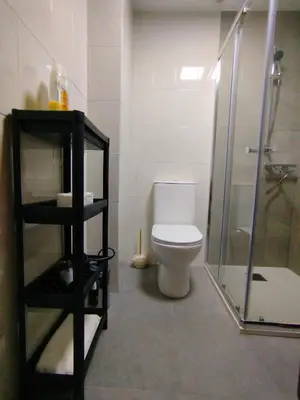 a bathroom with a toilet and a glass shower at MARSÁN in Arzúa