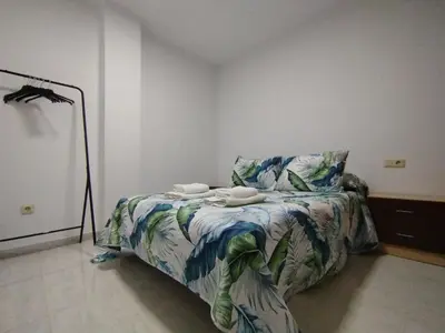 a bedroom with a bed with two towels on it at MARSÁN in Arzúa