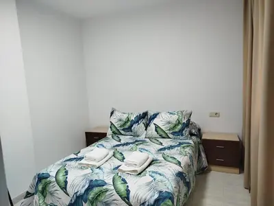 a bed with towels on it in a bedroom at MARSÁN in Arzúa