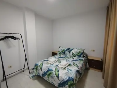 a bedroom with a bed with two phones on it at MARSÁN in Arzúa