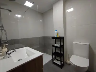 a bathroom with a sink and a toilet and a mirror at MARSÁN in Arzúa