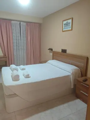 a bedroom with a bed with towels on it at Restaurante y Hostal San Paio in Santiago de Compostela
