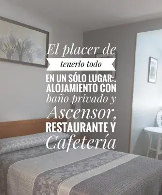 a bedroom with a bed with a sign on the wall at Restaurante y Hostal San Paio in Santiago de Compostela