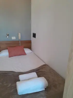 a bedroom with a bed with two pillows on it at Restaurante y Hostal San Paio in Santiago de Compostela