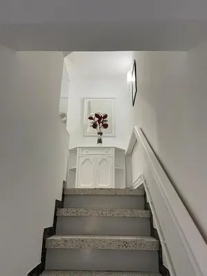 a staircase with a vase with a flower in it at VT Maria in Ribadeo
