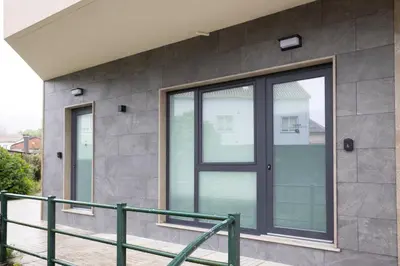 a glass door on the side of a building at Huna Apartamentos in Padrón