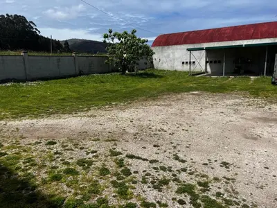 a building with a red roof and a grass field at APARTAMENTO FOZ Imr in Foz