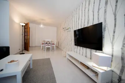 a living room with a television on a wall at Dulces Estancias in Lalín