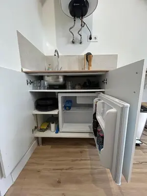 a kitchen with a sink and an open refrigerator at Catapiriño - Confort Elegante y Exclusivo en el Corazón de la Ciudad in Ourense