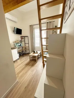 a room with a staircase and a living room at Catapiriño - Confort Elegante y Exclusivo en el Corazón de la Ciudad in Ourense