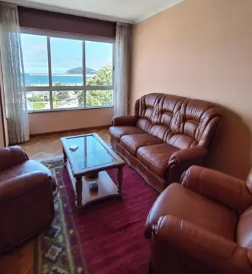 a living room with leather couches and a coffee table at Sobre la Playa in Covas
