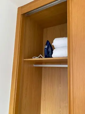 a wooden cabinet with some towels and towels at Apartamento a pie de playa La Pepa in Burela de Cabo