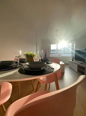 a dining room with a table with chairs and a tableablish at Apartamento a pie de playa La Pepa in Burela de Cabo