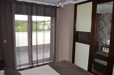 a bedroom with a window with a view of a balcony at Ático Xacobeo 360 views in Sarria