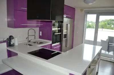 a purple kitchen with a sink and a refrigerator at Ático Xacobeo 360 views in Sarria