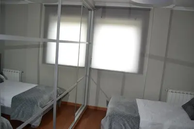 a small room with two beds and a window at Ático Xacobeo 360 views in Sarria