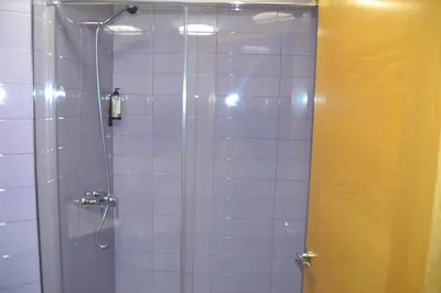 a bathroom with a shower with a glass door at Ático Xacobeo 360 views in Sarria