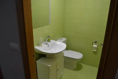 a bathroom with a sink and a toilet at Ático Xacobeo 360 views in Sarria