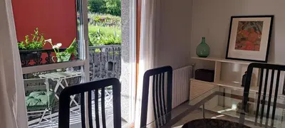 a dining room with a glass table and a balcony at Casa Castrexa in Novoa