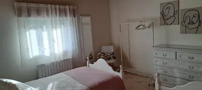 a bedroom with a bed and a dresser with a television at Casa Castrexa in Novoa