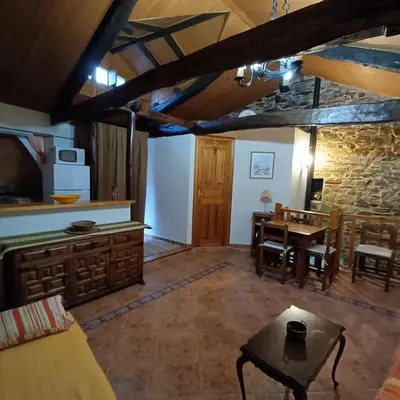 a living room with a table and a dining room at Casa del agua in Espinoso de Compludo