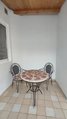 a table and two chairs in a room at Cuatro Calles Picarolas in Ribadeo