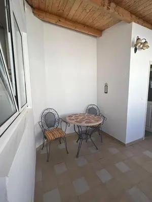 a table and two chairs in a room at Cuatro Calles Picarolas in Ribadeo