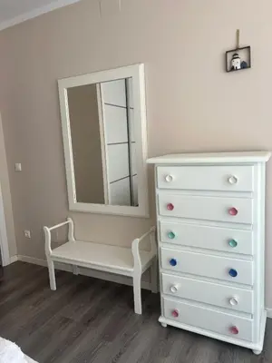 a bedroom with a white dresser and a mirror at Cuatro Calles Picarolas in Ribadeo