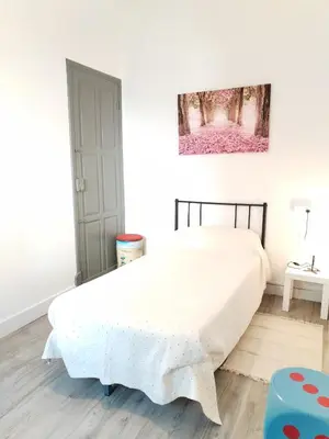 a bedroom with a bed and a painting on the wall at Yellow House in Viveiro