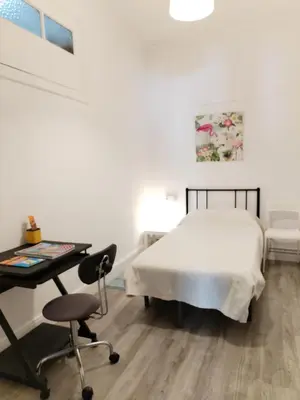 a bedroom with a bed and a desk and a chair at Yellow House in Viveiro