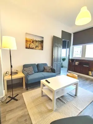 a living room with a couch and a table at Yellow House in Viveiro