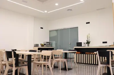 a conference room with tables and chairs and a screen at Pensión Casa Cruceiro in Arzúa