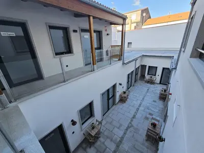 an empty balcony of a building with benches on it at Pensión Casa Cruceiro in Arzúa