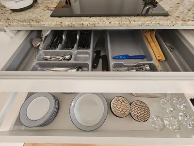a drawer in a kitchen with dishes and utensils at Apartamento Casa Cruceiro in Arzúa