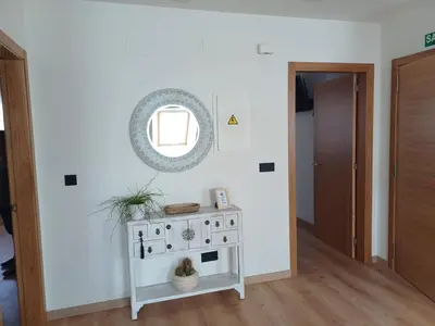 a white stove in a room with a mirror at Apartamento Casa Cruceiro in Arzúa