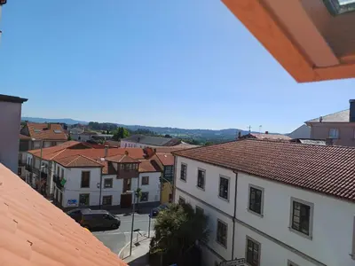 a view of a town with buildings and a street at Apartamento Casa Cruceiro in Arzúa