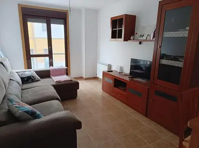 a living room with a couch and a tv at Mi Morada - Apartamento in Lalín