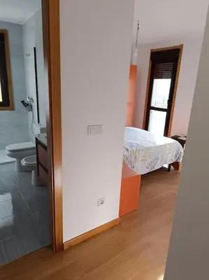 a room with a bedroom with a bed and a bathroom at Mi Morada - Apartamento in Lalín