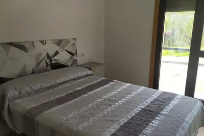 a bedroom with a bed and a window at Mi Morada - Apartamento in Lalín