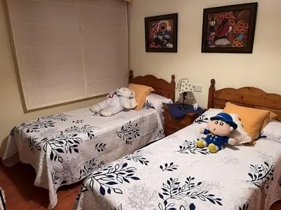 two beds with stuffed animals sitting on them in a bedroom at O xualtar Océano 2 in Villadaíde